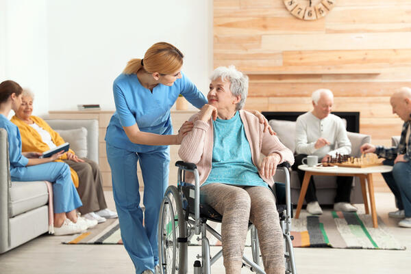 Nurses assisting elderly people at retirement home